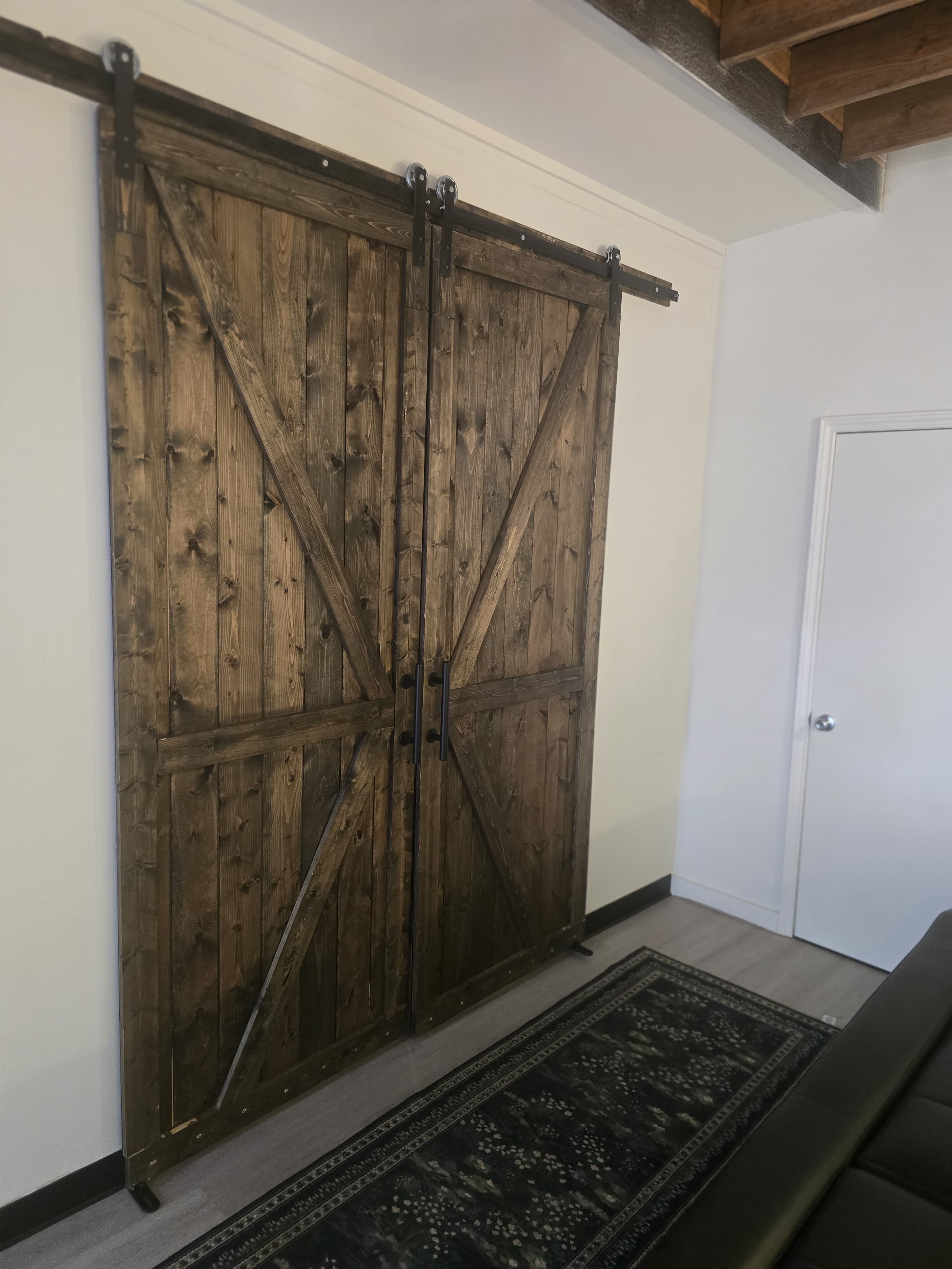 Rustic barn doors leading to treatment rooms