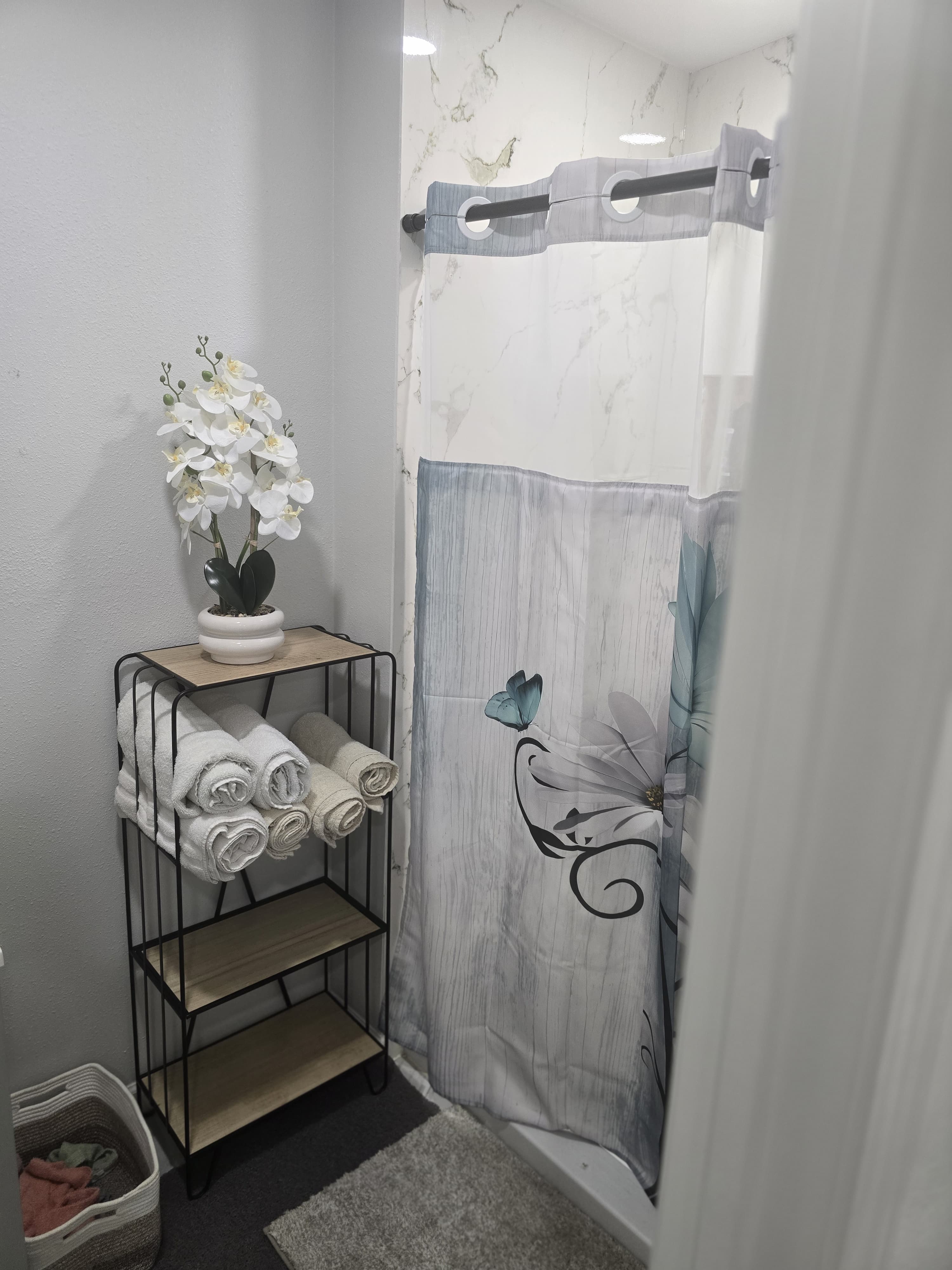 Spa shower area with fresh towels and amenities