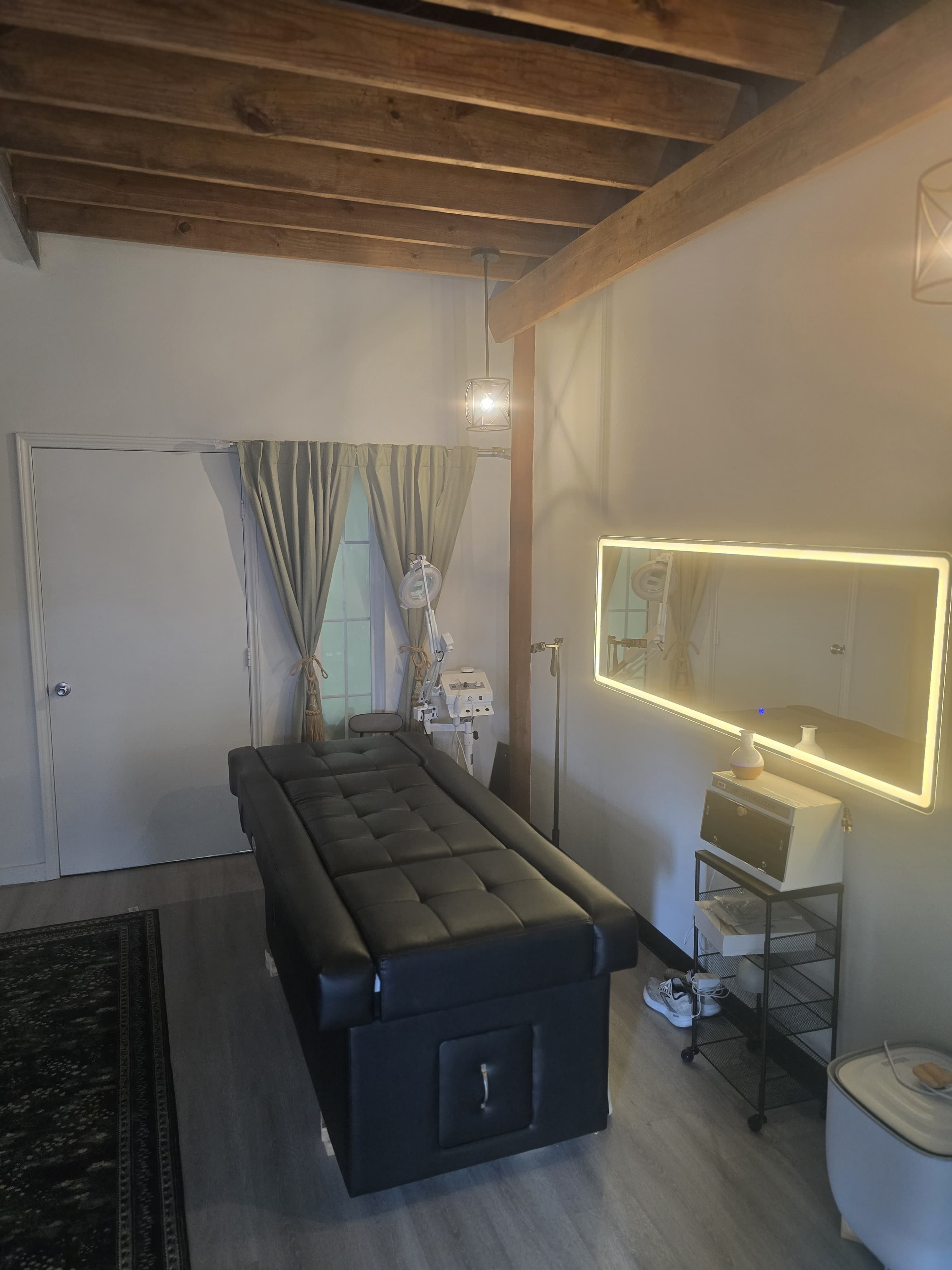 Treatment room with backlit mirror and professional equipment